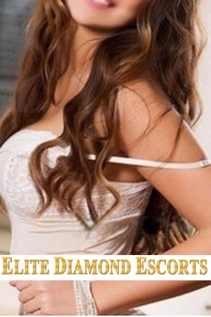 Pretty escort smailing at camera with long brown hair